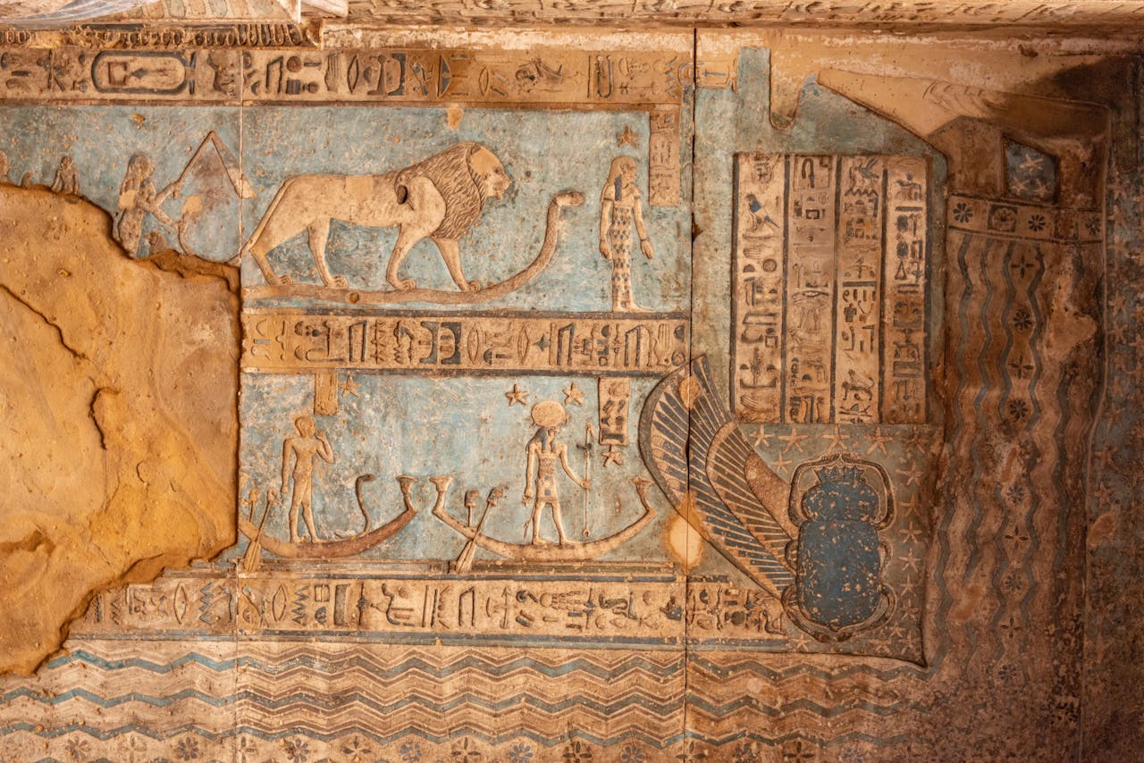 Detailed view of ancient Egyptian hieroglyphs and artwork on a temple wall.