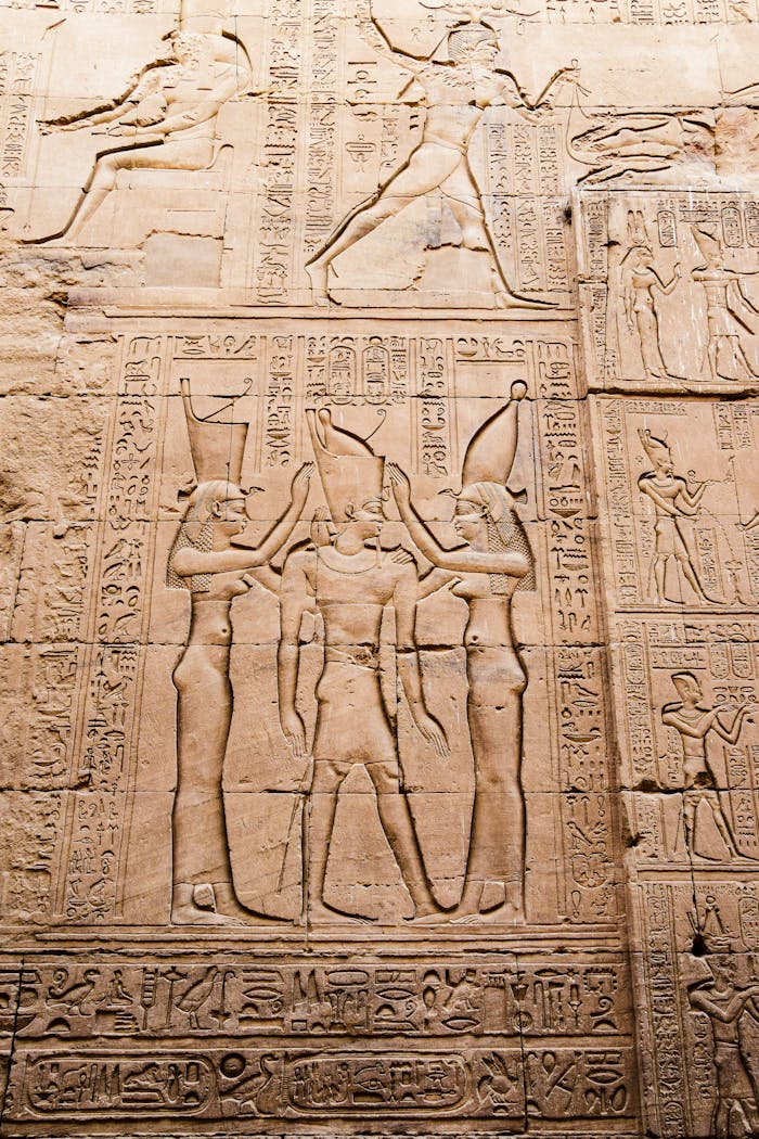 Close-up of intricate hieroglyphic carvings on an ancient Egyptian temple wall, showcasing historical narratives.